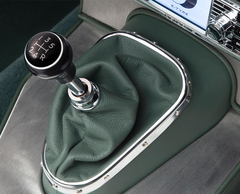 E-Type 5-speed gear lever with black knob and green leather boot.