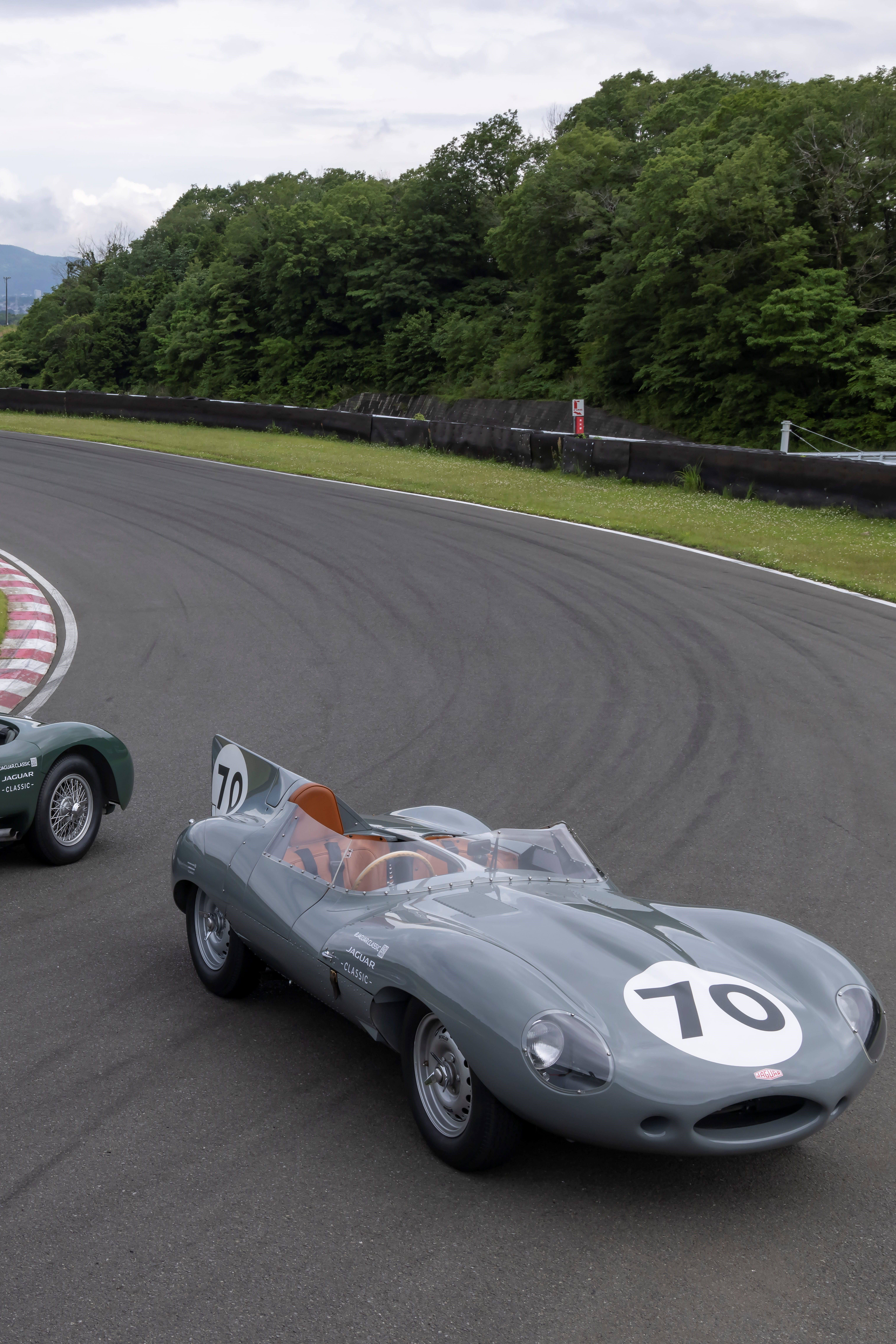 Front left wheel of a black Defender in an outdoor setting.